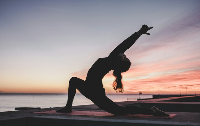 Silhouet van een vrouw die yoga doet